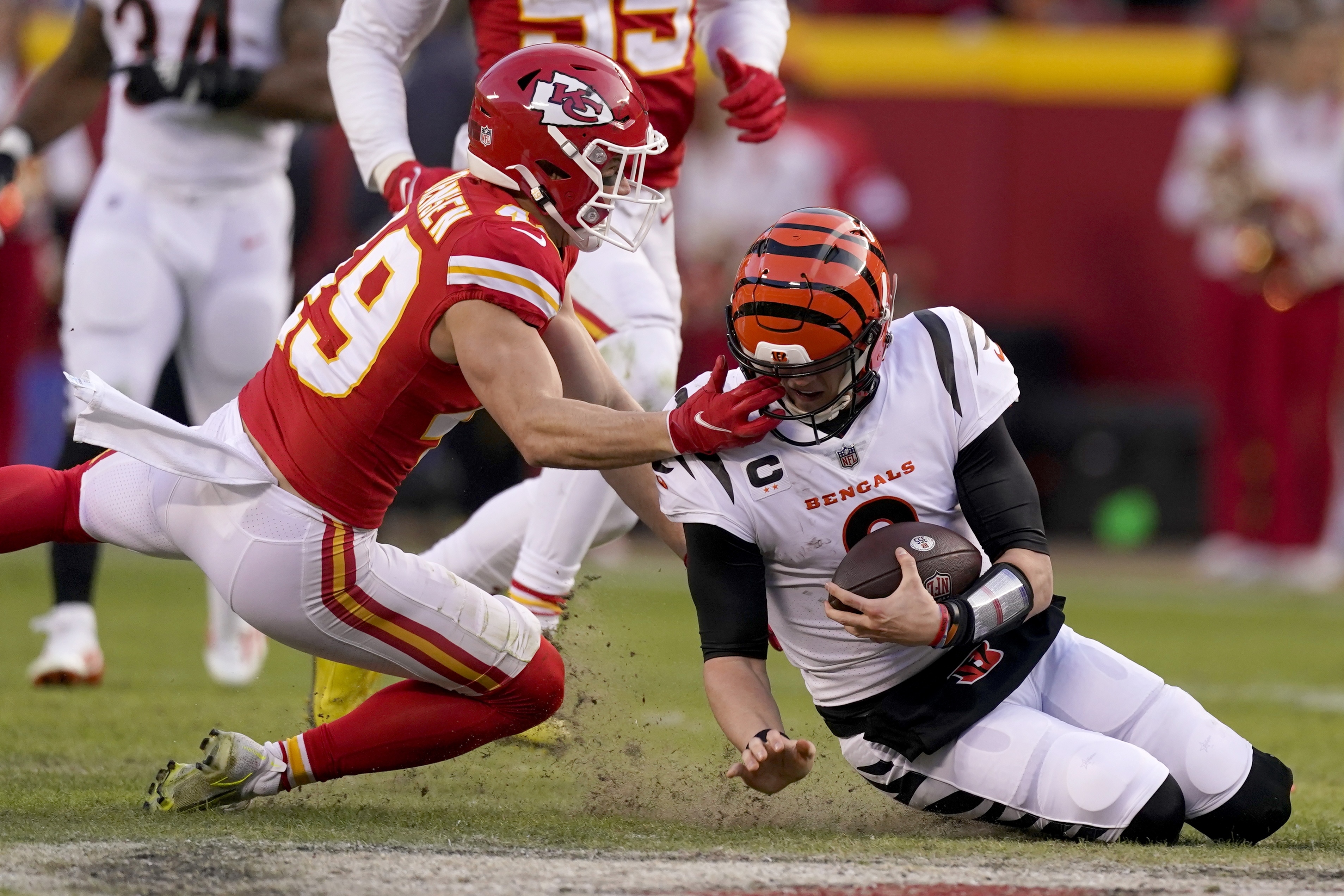 Kansas City Chiefs safety Daniel Sorensen (49) defends against a run by Cincinnati Bengals quarterback Joe Burrow, right, during the second half of the AFC championship NFL football game, Sunday, Jan. 30, 2022, in Kansas City, Mo.