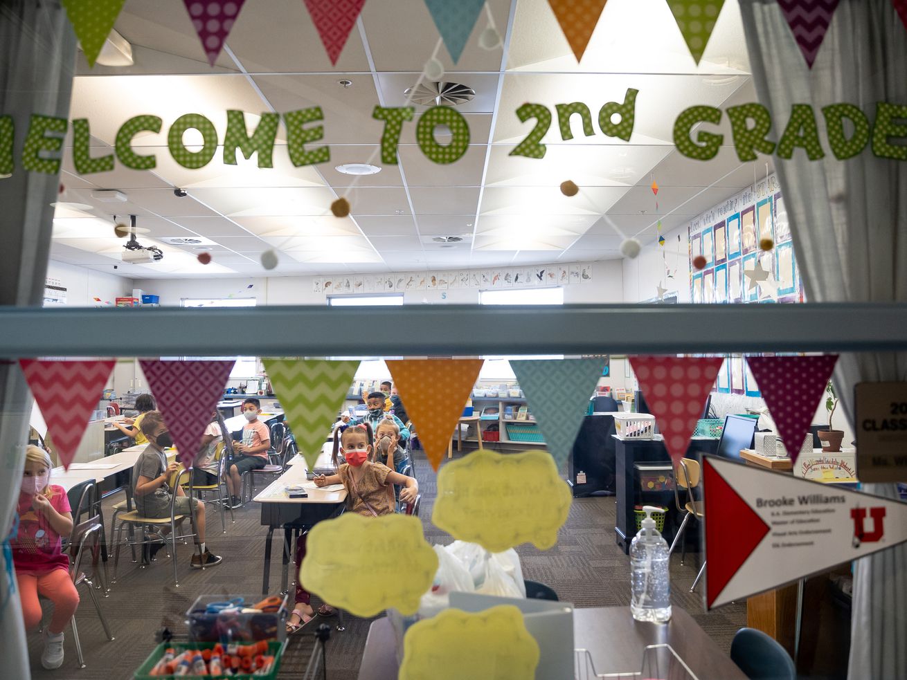 Second grade students are pictured through the window of their classroom at Nibley Park School in Salt Lake City on Aug. 24, 2021.