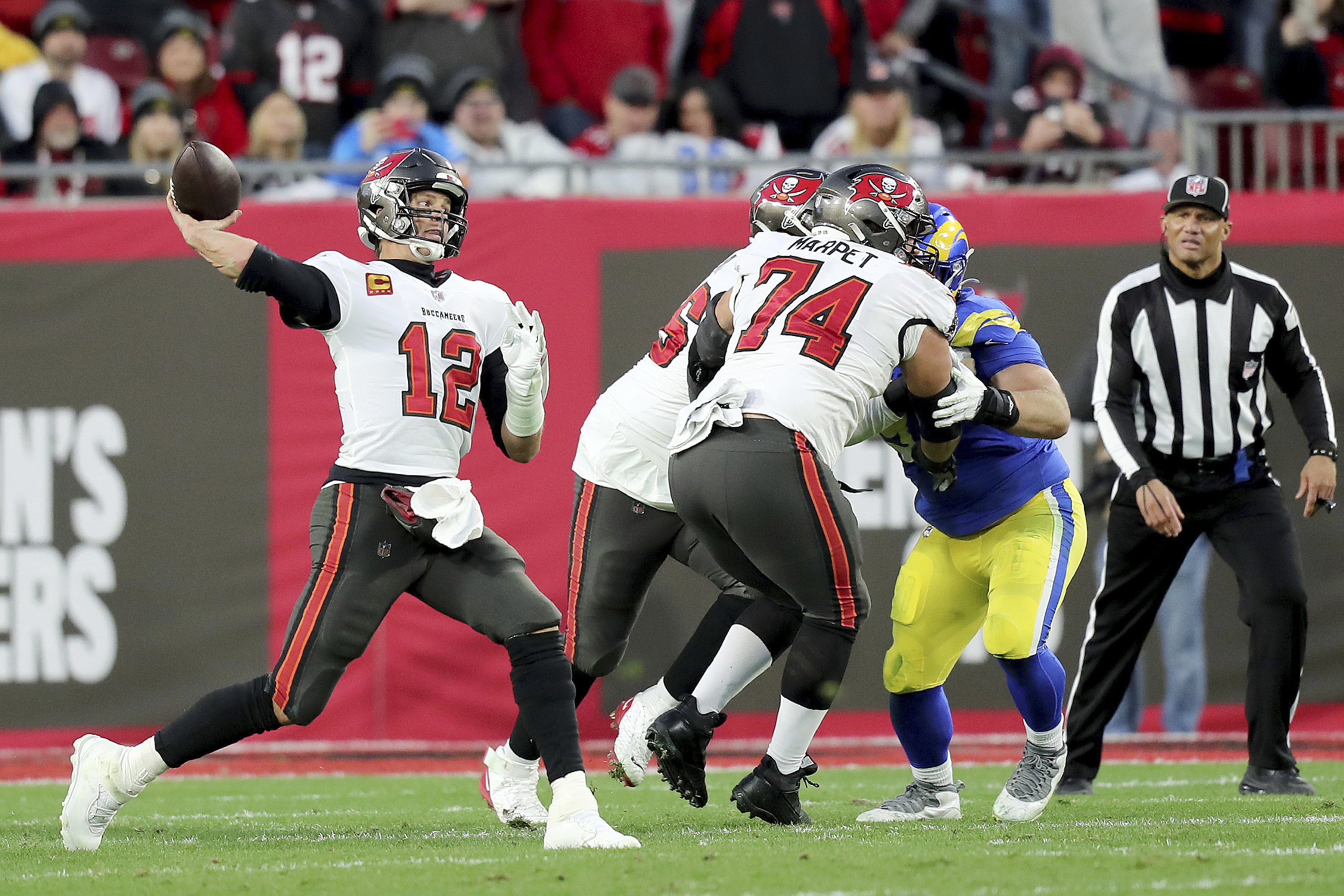 Tampa Bay Buccaneers quarterback Tom Brady (12) passes the ball as Tampa Bay Buccaneers guard Ali Marpet (74) blocks during a NFL divisional playoff football game between the Los Angeles Rams and Tampa Bay Buccaneers, Jan. 23, 2022, in Tampa, Fla.