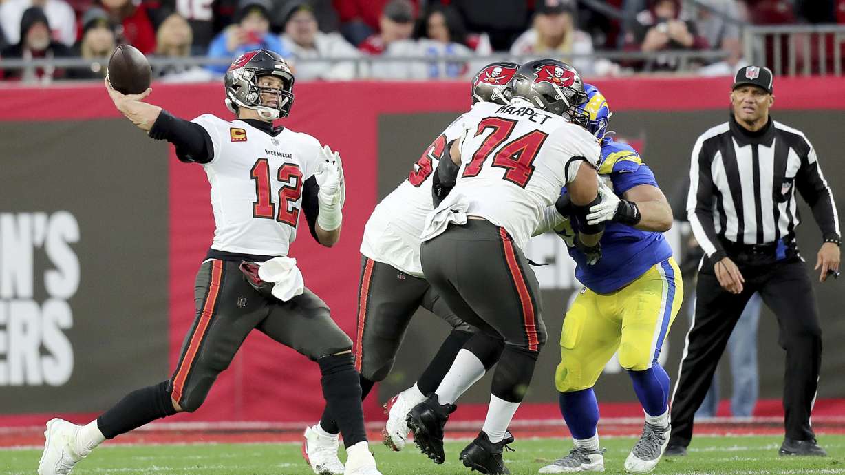 Tampa Bay Buccaneers quarterback Tom Brady (12) passes the ball as Tampa Bay Buccaneers guard Ali Marpet (74) blocks during a NFL divisional playoff football game between the Los Angeles Rams and Tampa Bay Buccaneers, Jan. 23, 2022, in Tampa, Fla.