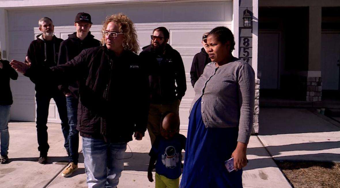 Jimi Pitts and Zyningira Zchimpayi stand in front of the car Pitts gave to Zchimpayi.