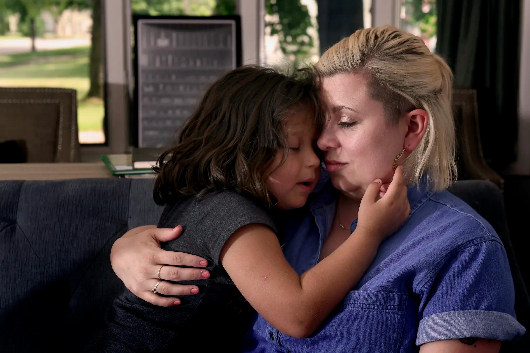 Winnie Buck, then 5 years old, snuggles with mom Melissa Buck at the family’s home in Holt, Michigan, on Monday, June 11, 2018. Melissa and Chad Buck adopted their five children through St. Vincent Catholic Charities in Michigan. 