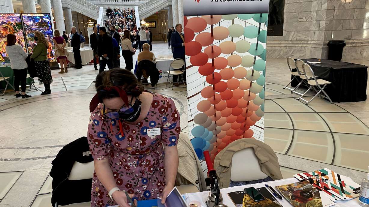 A member of Utah Division of Arts & Museums makes a button from copies of Utah works of art. A new report says Utah's cultural industry, which was hit hard by the pandemic, may be on the road to recovery.