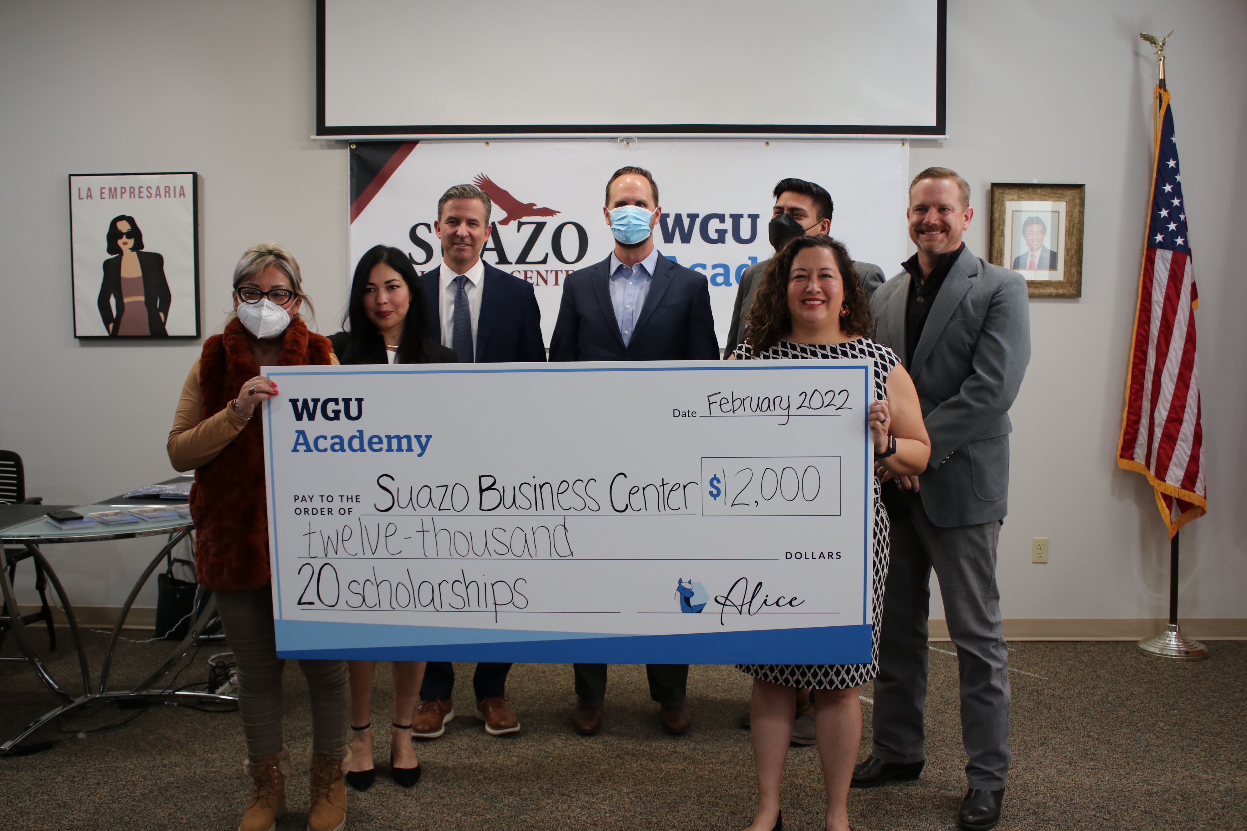 Claudia Gonzalez and Silvia Castro hold a check that will be used to fund tuition for students in the Western Governors University Academy pilot initiative while Rossina Lake, Chris Lee, Jevon Gibb, Alejandro Puy and Edward Bennett look on, Tuesday. WGU Academy on Tuesday announced a partnership with Suazo Business Center that will provide Utahns from underserved communities with college-readiness education scholarships.