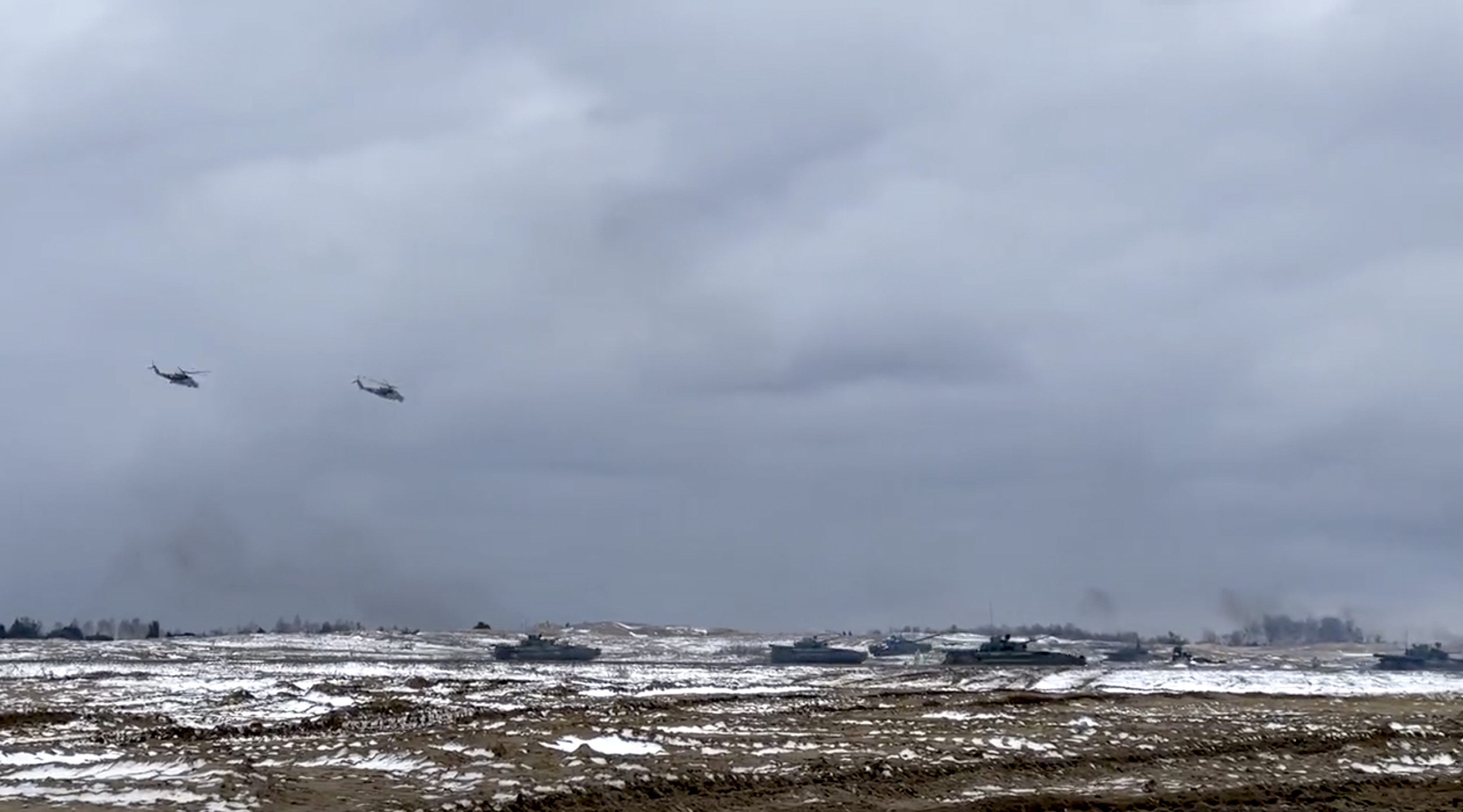 In this photo taken from video and released by the Russian Defense Ministry Press Service on Wednesday, Russian and Belarusian tanks and military helicopters attend a joint military drills at Brestsky firing range, Belarus.