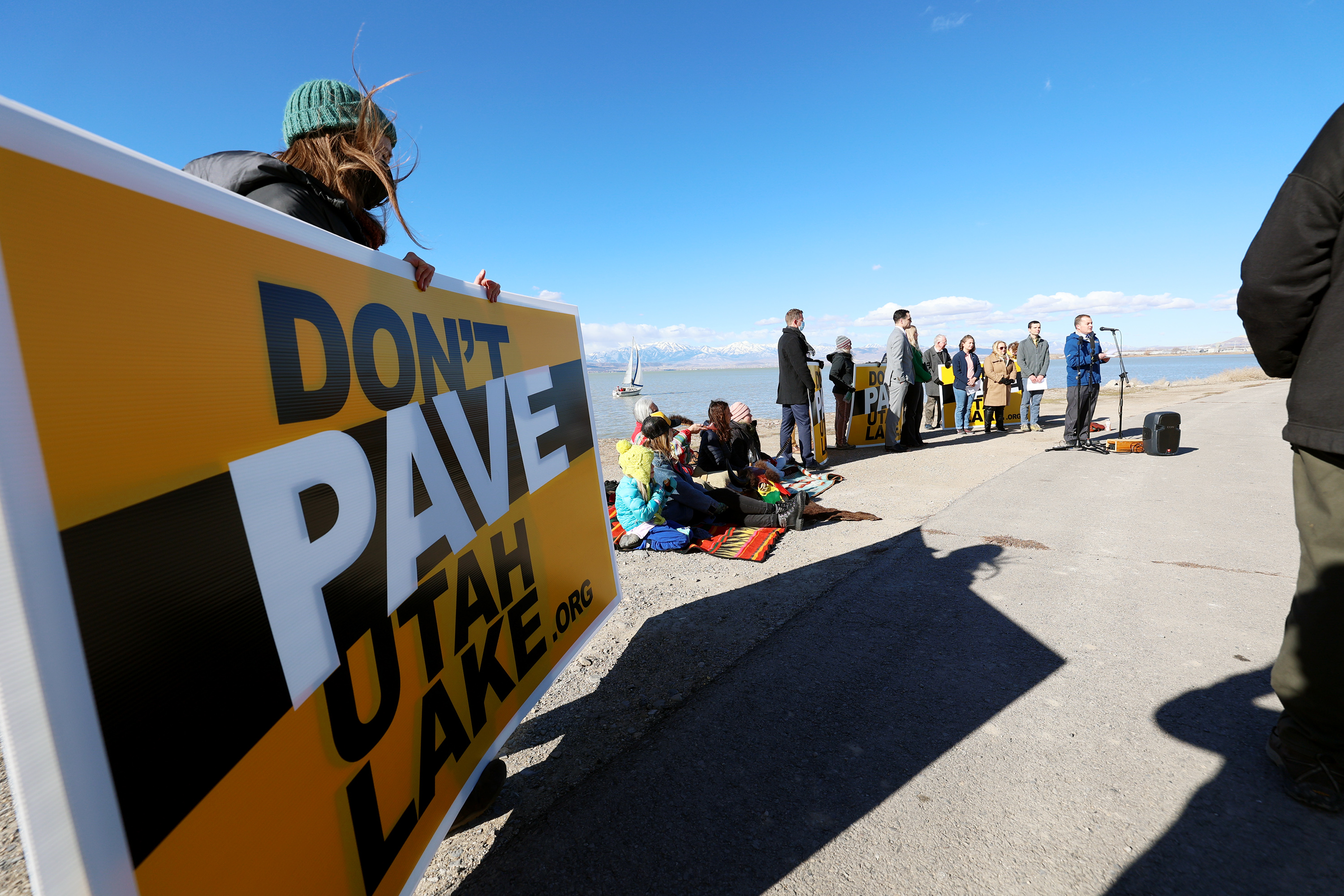 Signs reading “Don’t Pave Utah Lake.org” are pictured during a press conference on the shores of Utah Lake in Lindon, on Tuesday.