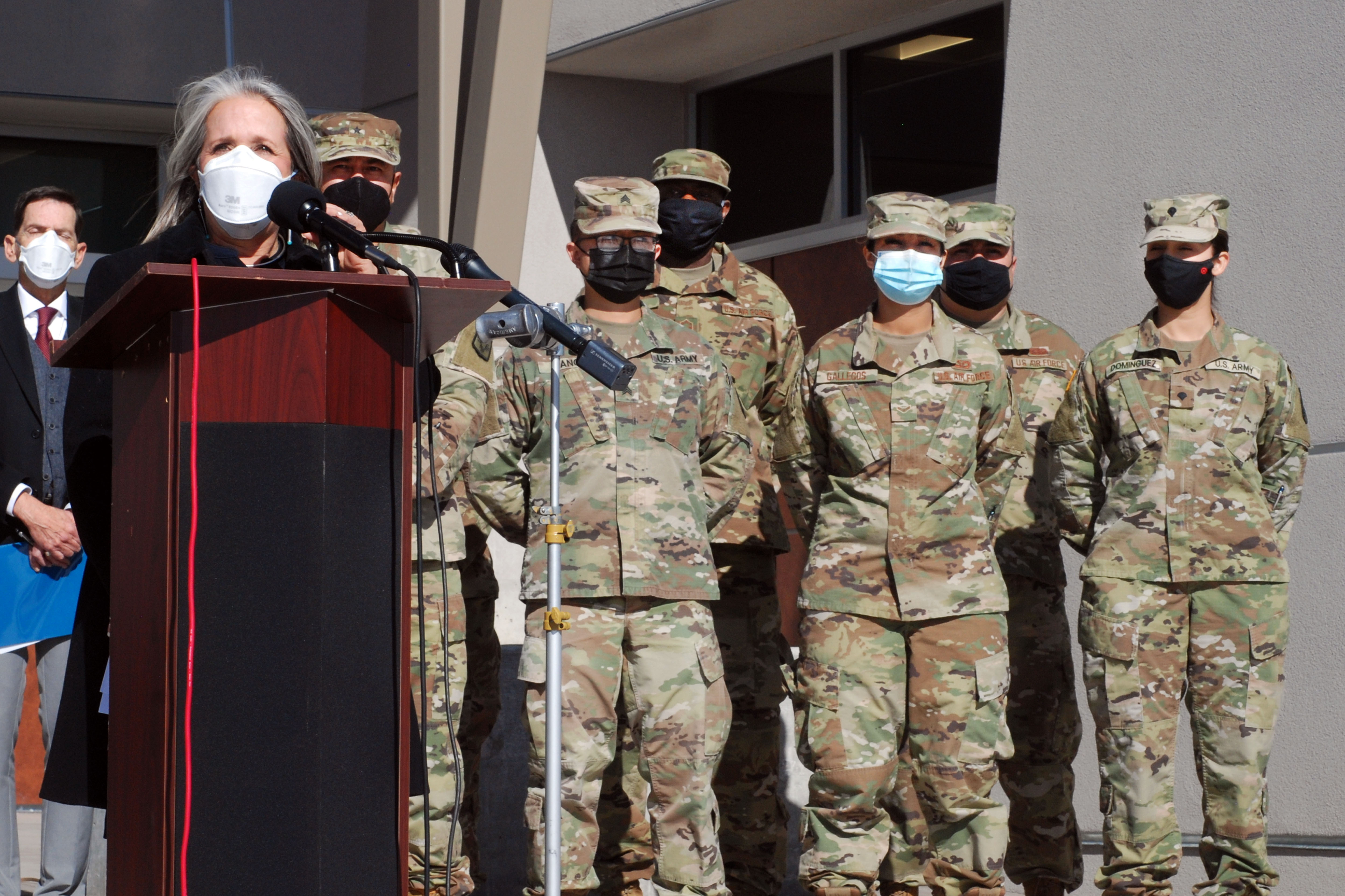 New Mexico Gov. Michelle Lujan Grisham, left, announced efforts to temporarily employ National Guard troops and state bureaucrats as substitute teachers and preschool caregivers, during a news conference, at Sante Fe High School, in Santa Fe, N.M., Jan. 19.