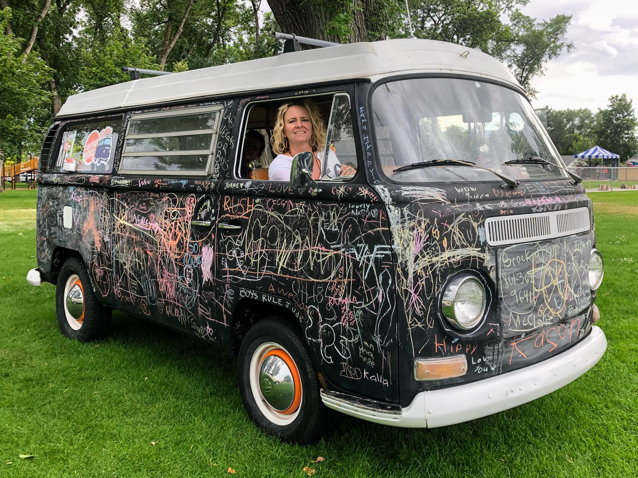 Kara Sherman is pictured in the bus she has supported through the years.  Her husband, Jonathan Sherman, made the 1969 VW Bus into an interactive mobile art project after thier 12-year-old daughter drew on the black-primered VW several years ago.