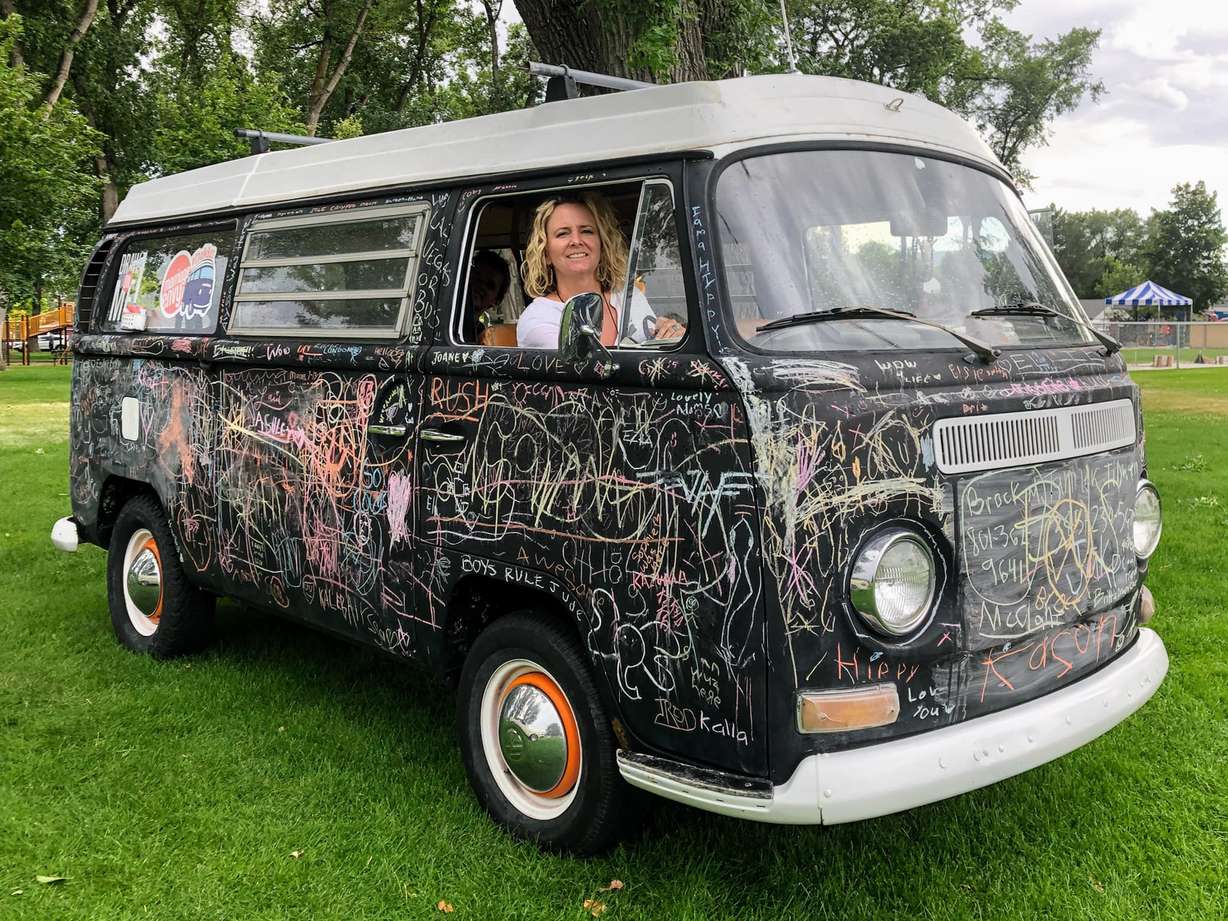Kara Sherman is pictured in the bus she has supported through the years. Her husband, Jonathan Sherman, made the 1969 VW Bus into an interactive mobile art project after thier 12-year-old daughter drew on the black-primered VW several years ago.