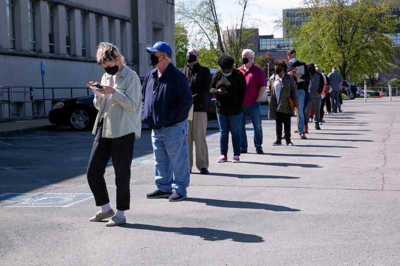 People line up outside a newly reopened career center for in-person appointments in Louisville, Kentucky, April 15, 2021. The number of Americans filing new claims for unemployment benefits fell more than expected last week, the labor department announced Thursday.