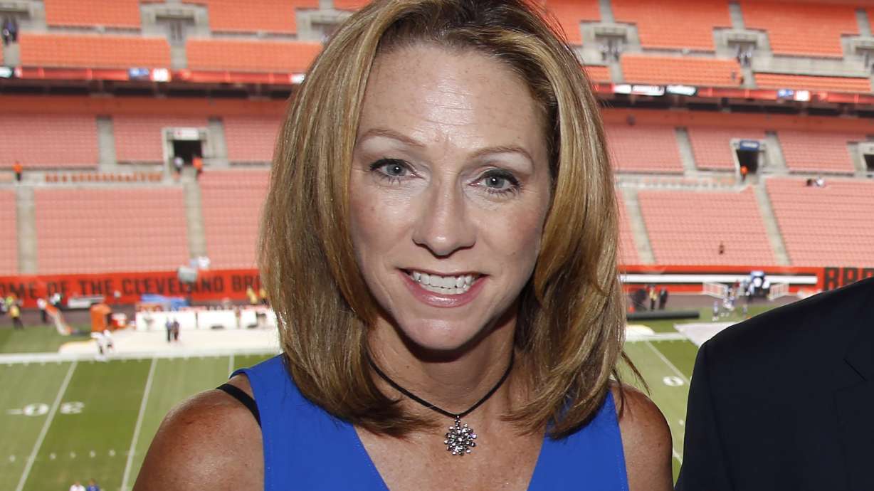 ESPN broadcaster Beth Mowins poses in the booth before an NFL football game between the New York Giants and the Cleveland Browns, Monday, Aug. 21, 2017, in Cleveland.