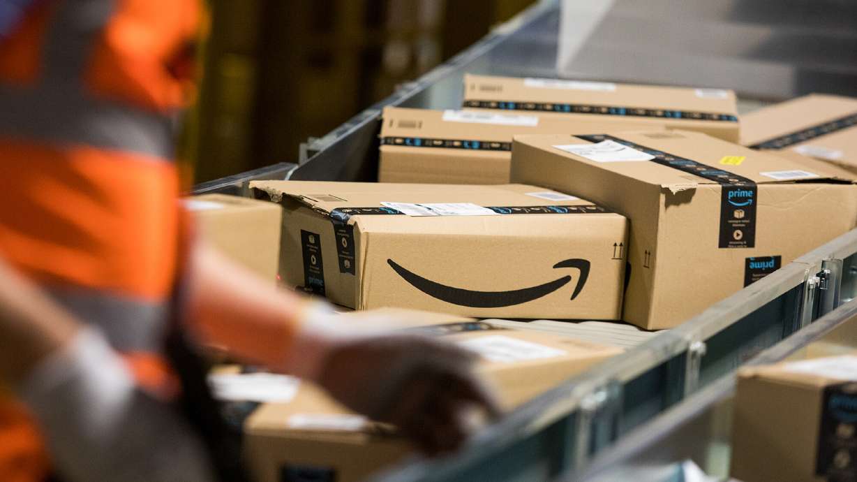 Packages sit on a conveyor belt at an Amazon fulfillment center. Amazon is raising the price of its annual Prime subscriptions from $119 to $139 per year in the United States, the company announced along with its earnings report Thursday.