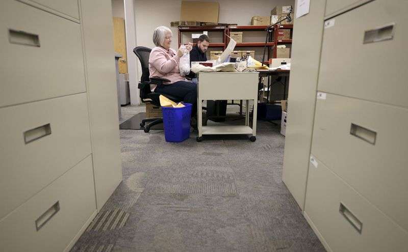 Janell Hall, Utah Unclaimed Property Division financial
manager, and Brandon Waite, Utah Unclaimed Property Division holder
team manager, sort through unclaimed properties at the Utah
Unclaimed Property Division office in Salt Lake City on Thursday.