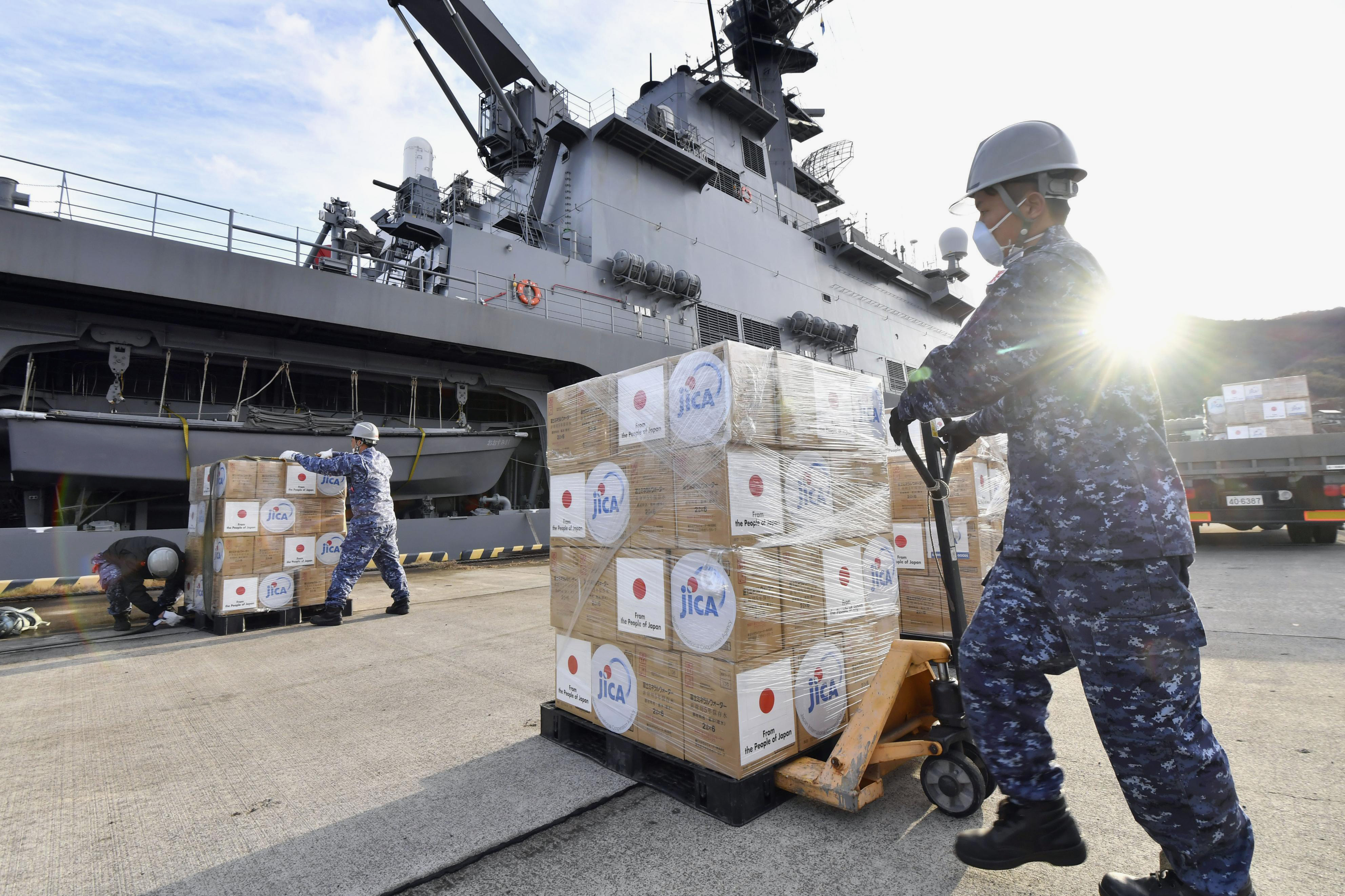 Members of the Japan Maritime Self-Defense Force load emergency relief aid bound for Tonga to a ship in Kure, near Hiroshima, western Japan, Jan. 24. The Pacific archipelago nation of Tonga is in lockdown after detecting its first community transmission of COVID-19.