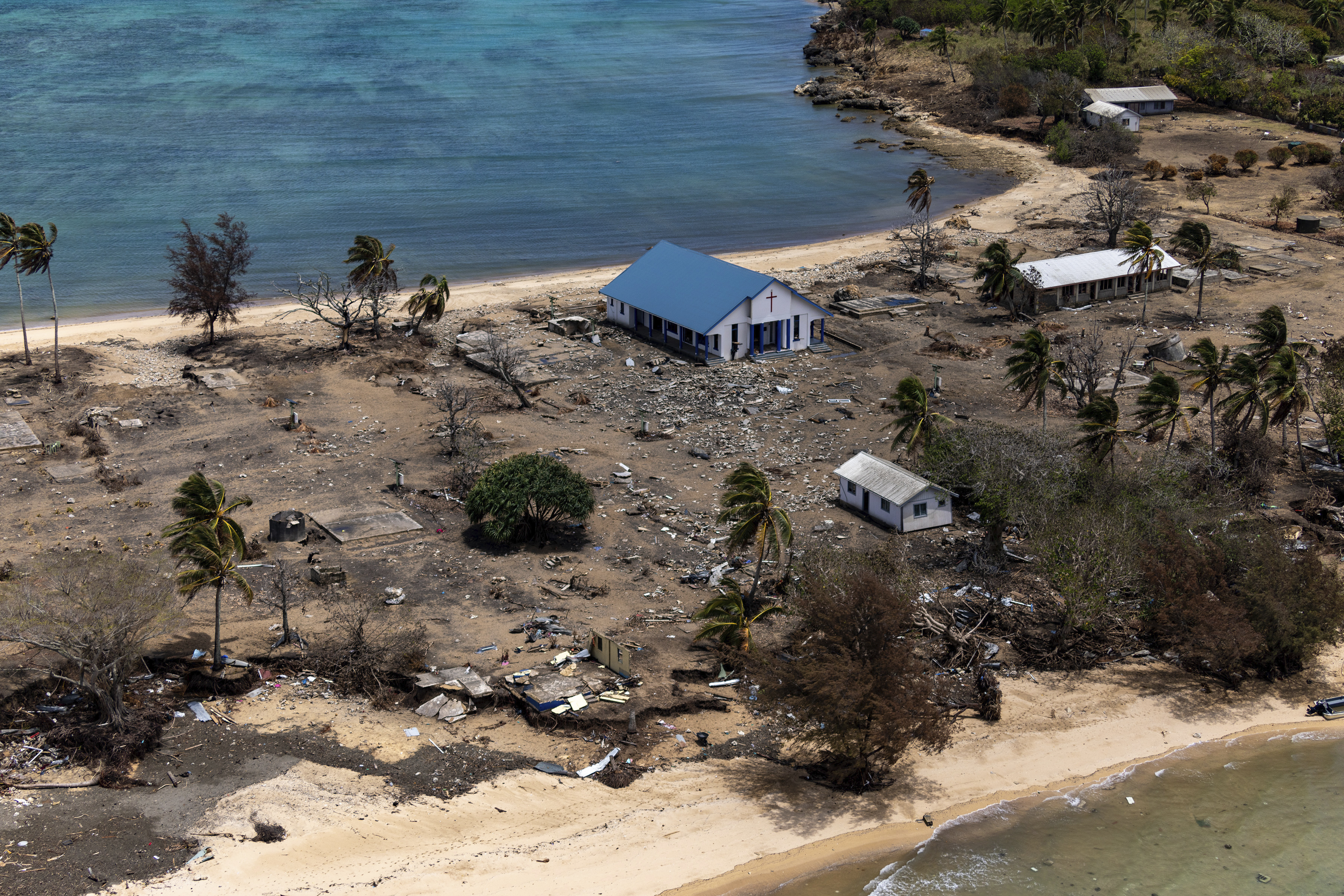 Debris from damaged building and trees are strewn around on Atata Island in Tonga, on Jan. 28, following the eruption of an underwater volcano and subsequent tsunami.