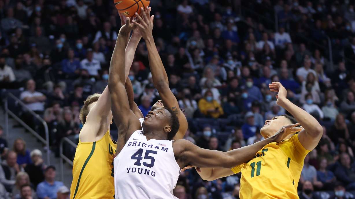 Brigham Young Cougars forward Fousseyni Traore (45) tries to grab a rebound over San Francisco Dons forward Patrick Tape (11) in Provo on Thursday, Feb. 3, 2022.