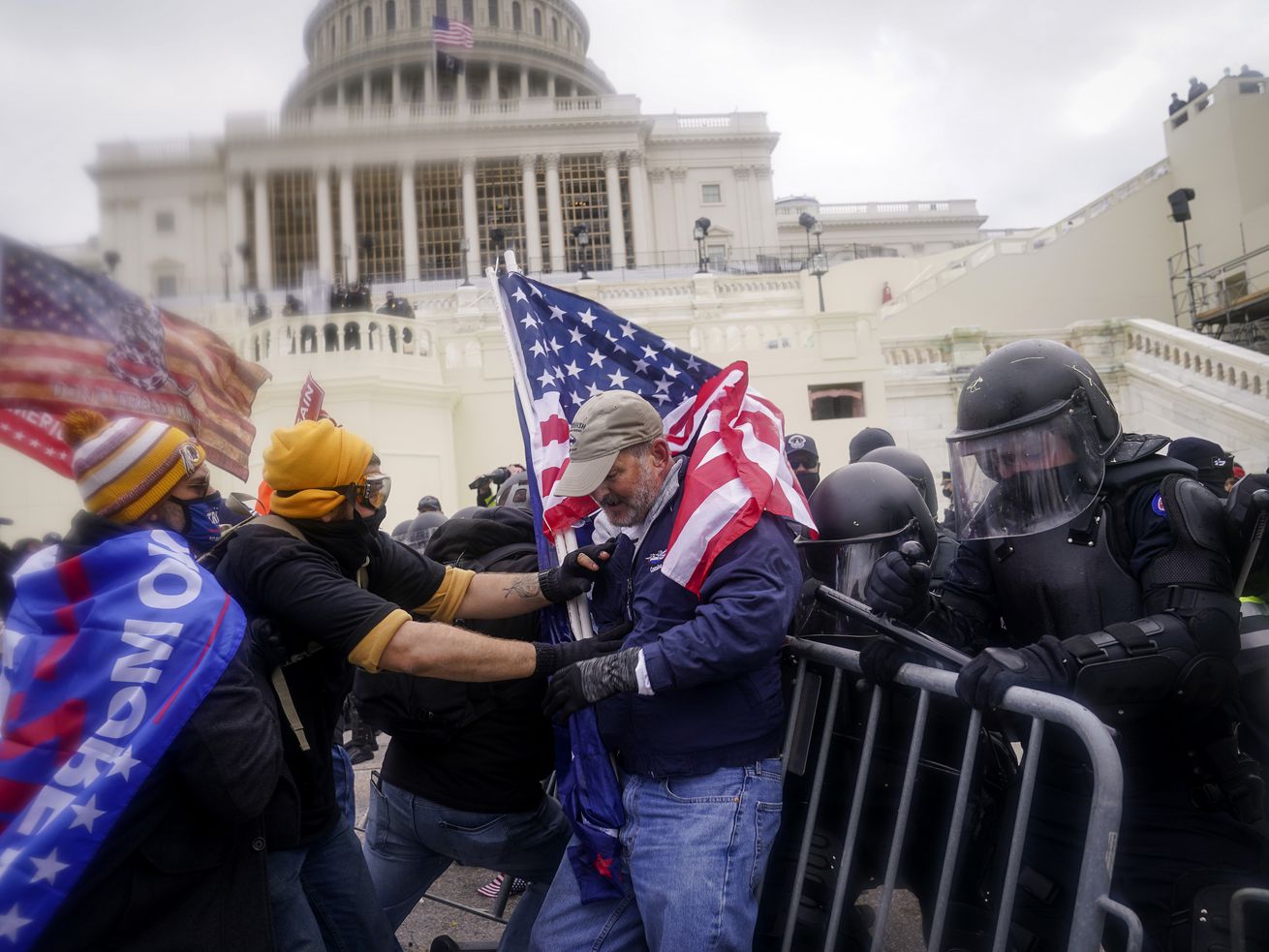 Rioters try to break through a police barrier at the
Capitol on Jan. 6, 2021, in Washington. A recent poll shows 10% of
Utah voters say they support the actions of those who broke into
the Capitol on Jan. 6 of last year, while 82% say they do not
support them.
