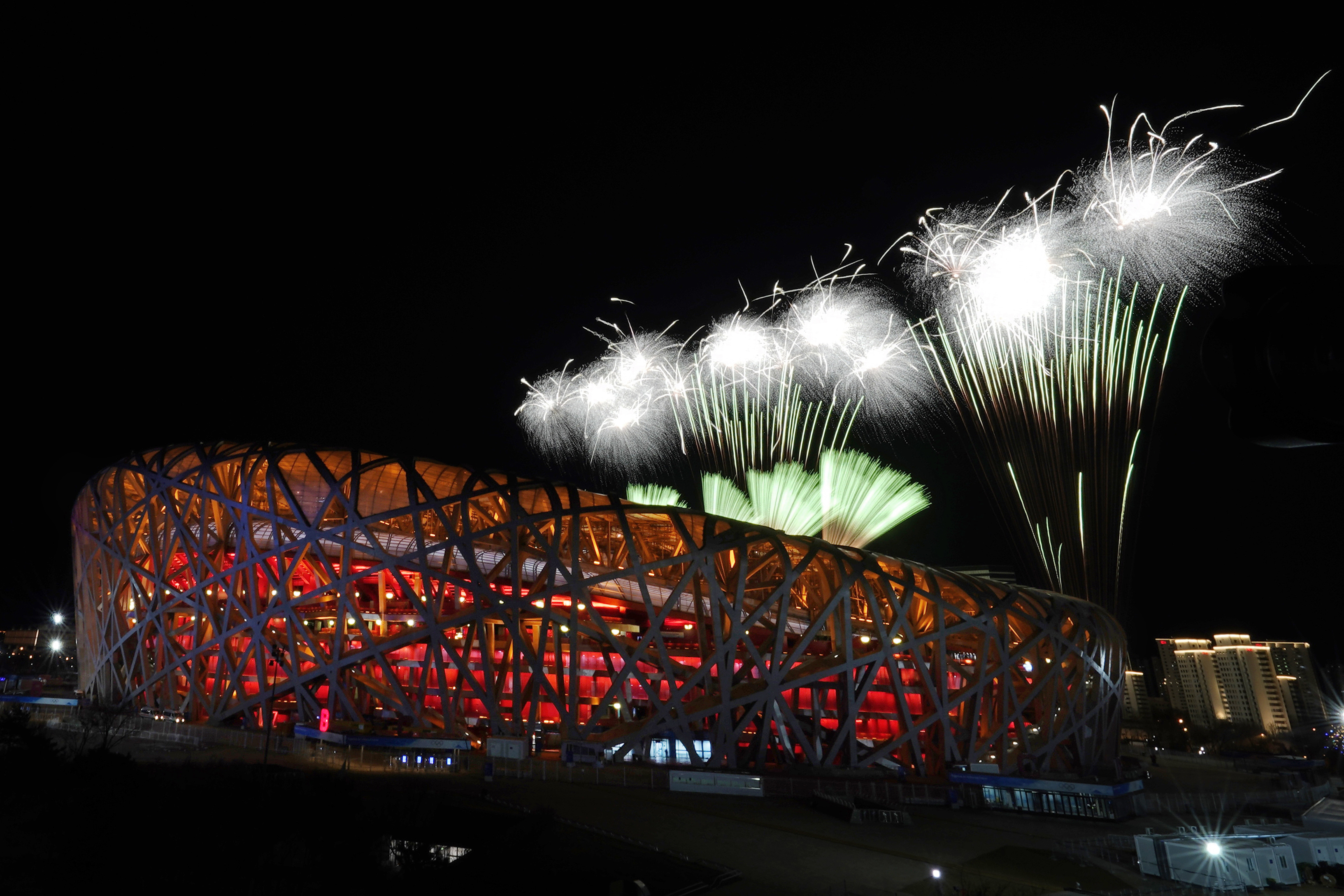 Fireworks explode over the National Stadium during the opening ceremony of the 2022 Winter Olympics, Friday, in Beijing.