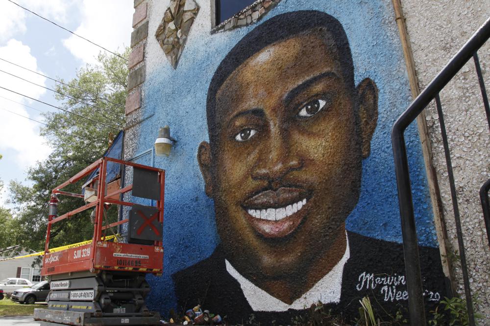 This May 17, 2020, photo shows a mural depicting Ahmaud Arbery in Brunswick, Ga.