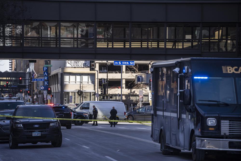 Police investigate a shooting in Minneapolis, Minn., on Wednesday. A Minneapolis police officer fatally shot a male Wednesday who authorities say had a loaded gun in his hand. Interim police Chief Amelia Huffman said the shooting happened at about 7 a.m. Wednesday in a downtown apartment complex.