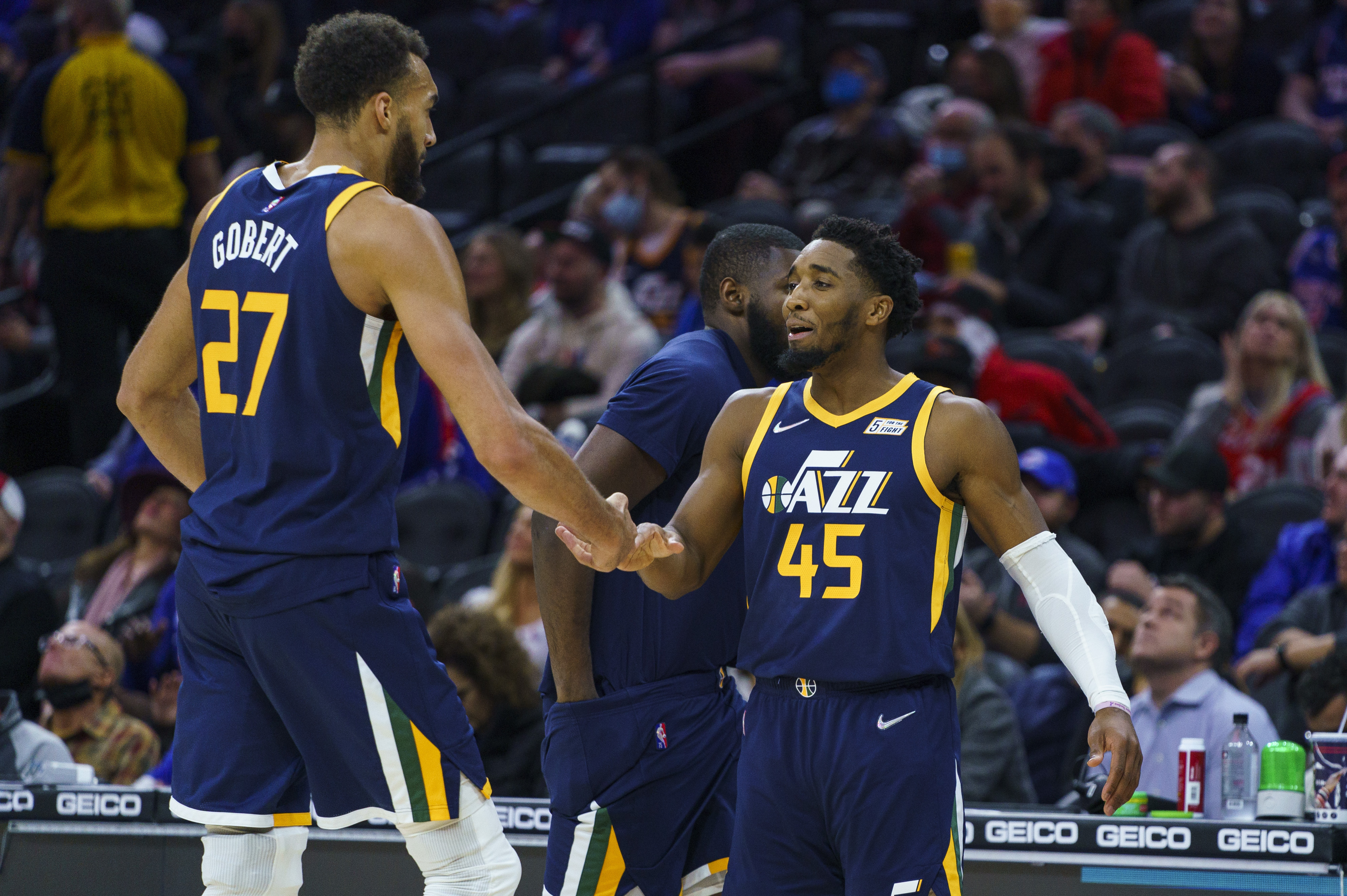 Utah Jazz's Donovan Mitchell, right, celebrates with Rudy Gobert during the second half of the team's NBA basketball game against the Philadelphia 76ers, Thursday, Dec. 9, 2021, in Philadelphia. The All-Star duo's relationship is once again in the news.