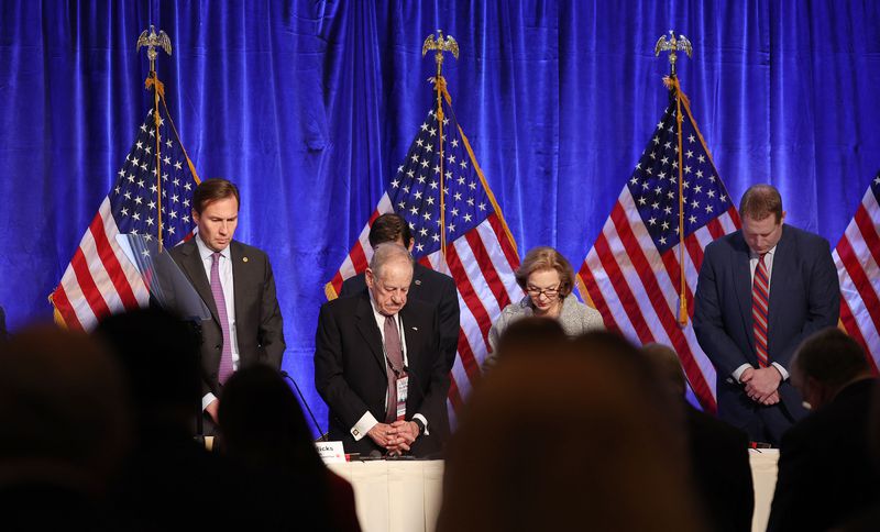 Attendees listen during an opening prayer during the
Republican National Committee general session at the Grand America
Hotel in Salt Lake City on Friday.