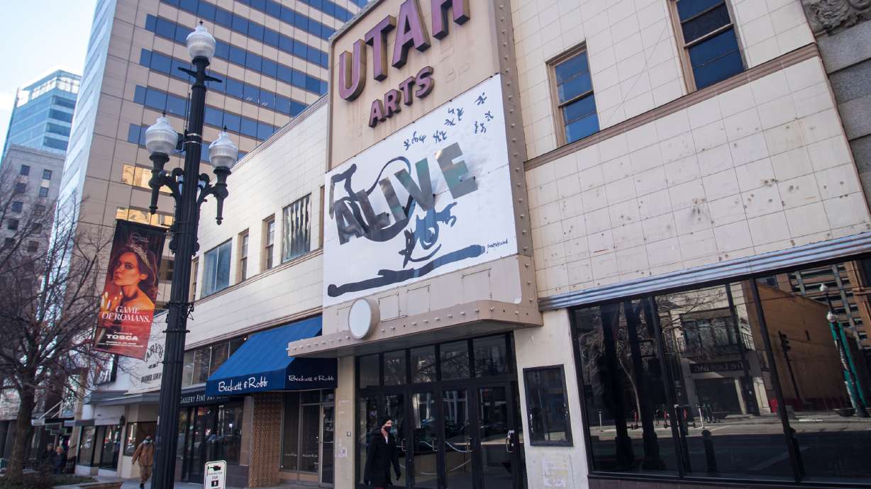 People walk past the exterior of the Utah Pantages Theater entrance on Main Street in Salt Lake City Friday. The company that formally acquired the property last year filed demolition permits last week.