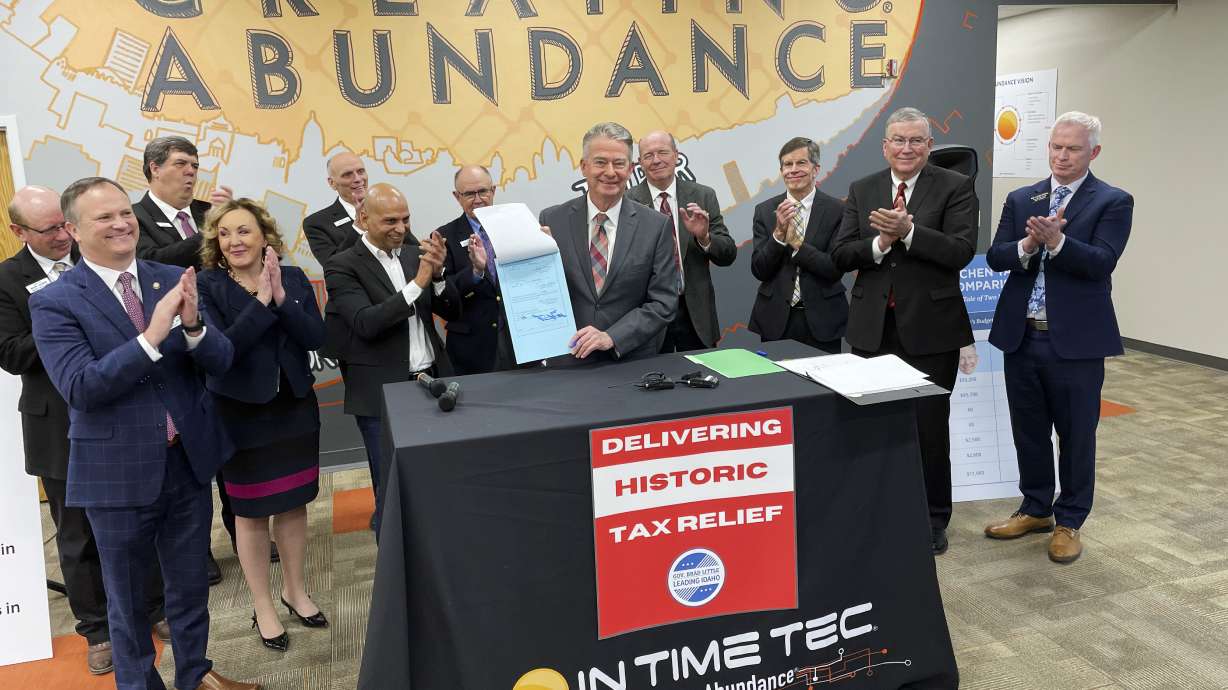 Idaho Gov. Brad Little, center, poses for photos with In Time Tec CEO Jeet Kumar, middle left, and Republican leaders from the House and Senate, after he signed into law a $600 million tax cut, the biggest tax cut in the state's history, at software company In Time Tec in Meridian, Idaho, Friday.