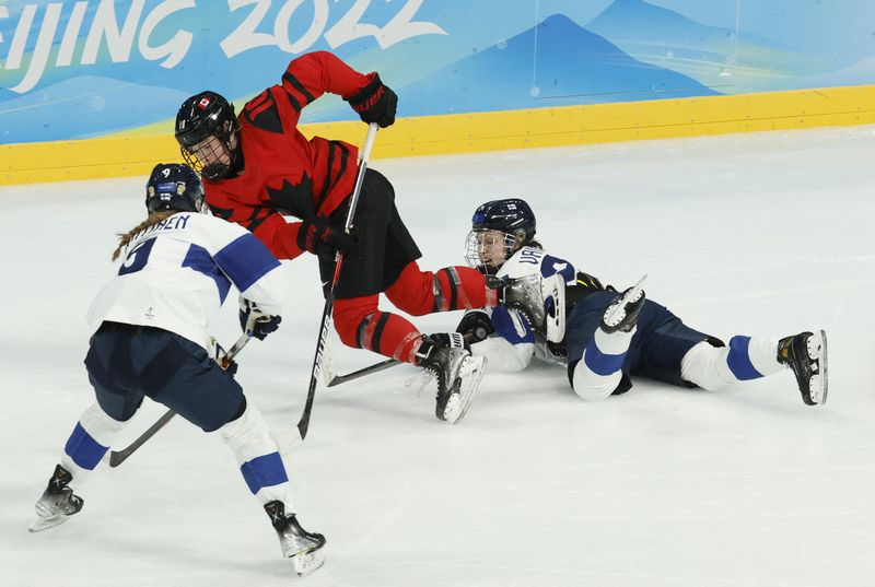 2022 Beijing Olympics - Ice Hockey - Women's Prelim. Round - Group A - Canada v Finland - Wukesong Sports Centre, Beijing, China - February 5, 2022. Sarah Fillier of Canada in action with Viivi Vainikka of Finland and Nelli Laitinen of Finland.