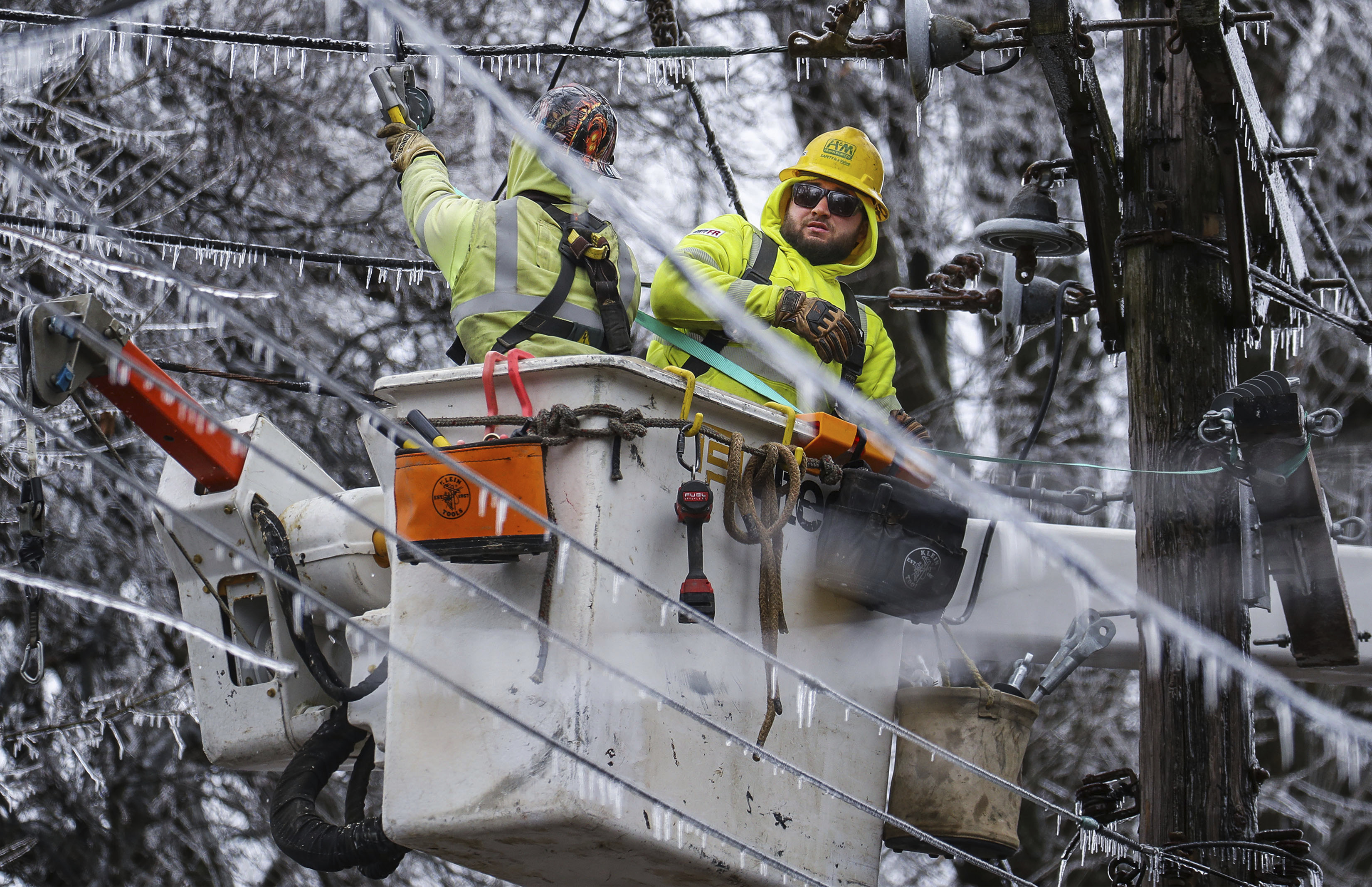 Crews work to restore power to the Central Garden neighborhood of Memphis, Tenn., on Friday. More than 120,000 customers were without power Friday afternoon in Shelby County, according to poweroutage.us, which tracks utility reports.  