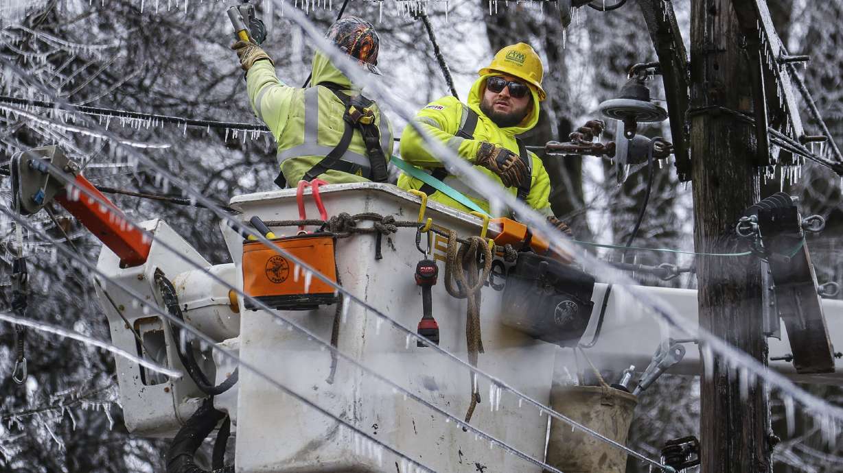 Crews work to restore power to the Central Garden neighborhood of Memphis, Tenn., on Friday. More than 120,000 customers were without power Friday afternoon in Shelby County, according to poweroutage.us, which tracks utility reports.