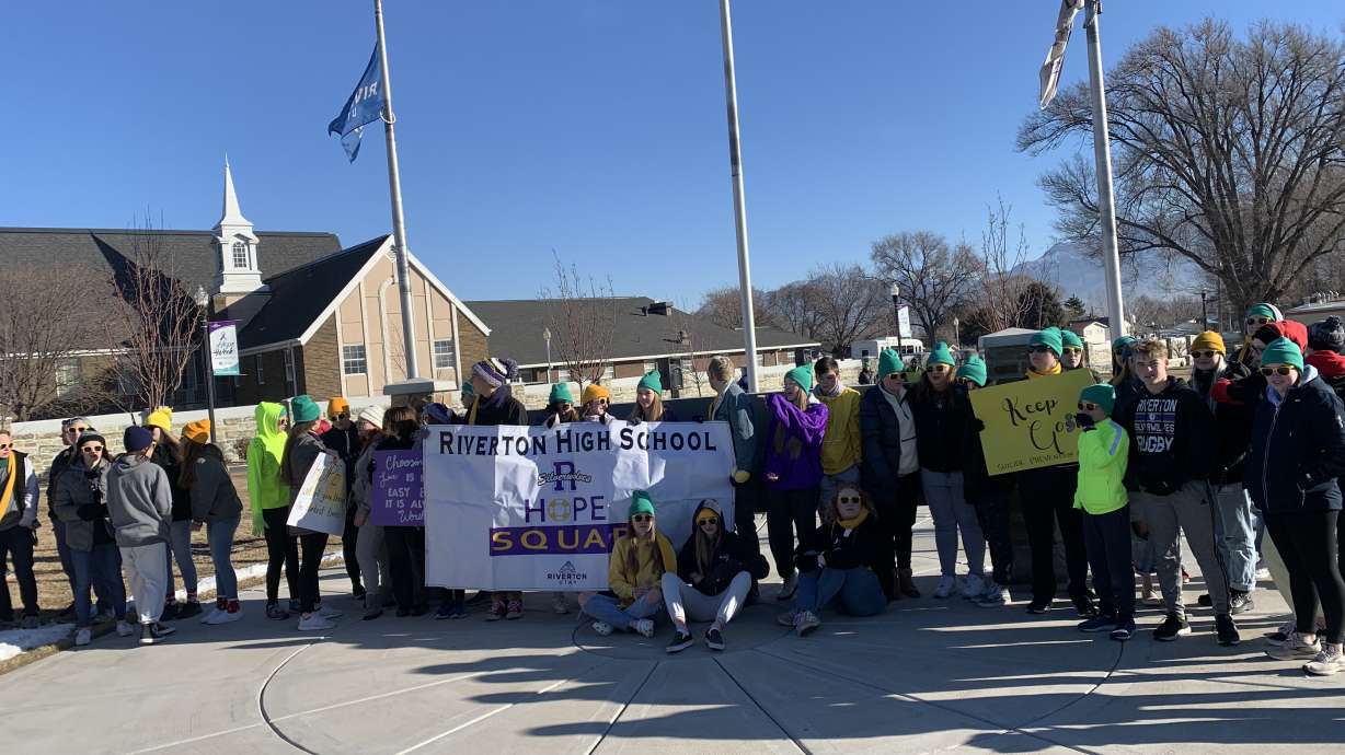 A group of students and community members participate in a Hope Walk that was held on Saturday to bring suicide awareness.