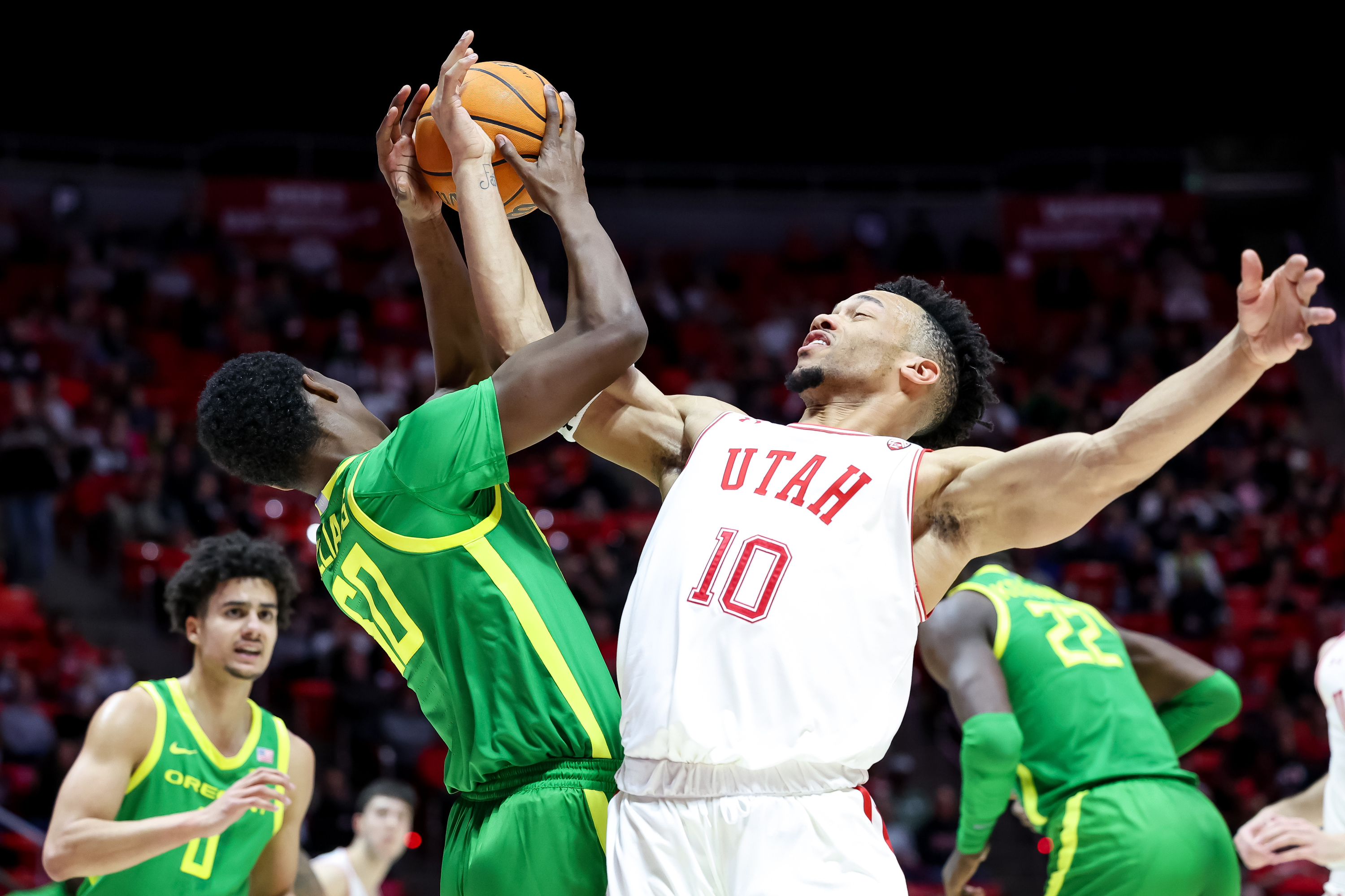 Oregon Ducks forward Eric Williams Jr. (50) and Utah Utes guard Marco Anthony (10) compete for a rebound during the game at the Huntsman Center in Salt Lake City on Saturday, Feb. 5, 2022.