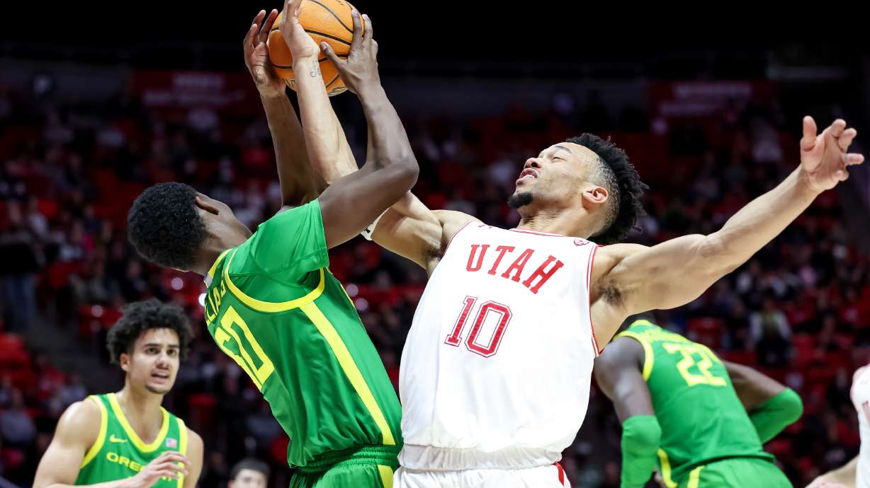 Oregon Ducks forward Eric Williams Jr. (50) and Utah Utes guard Marco Anthony (10) compete for a rebound during the game at the Huntsman Center in Salt Lake City on Saturday, Feb. 5, 2022.