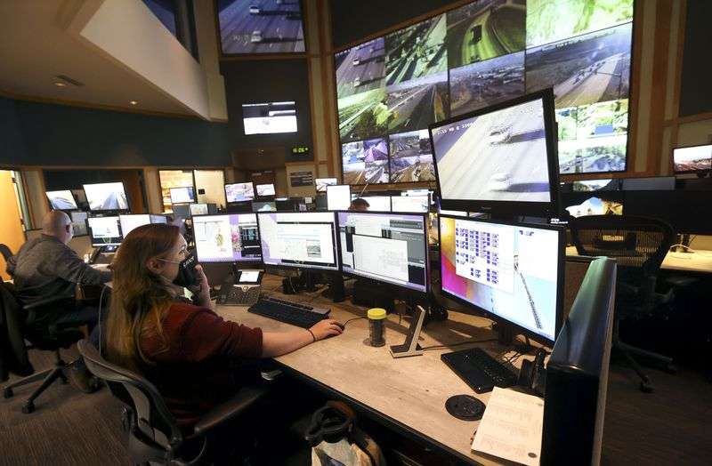 Nicole McCleery, Utah Department of Transportation
traffic management specialist, monitors traffic flow, traffic
cameras and radios at the UDOT Operations Center in Salt Lake City
on Monday, Jan. 24.