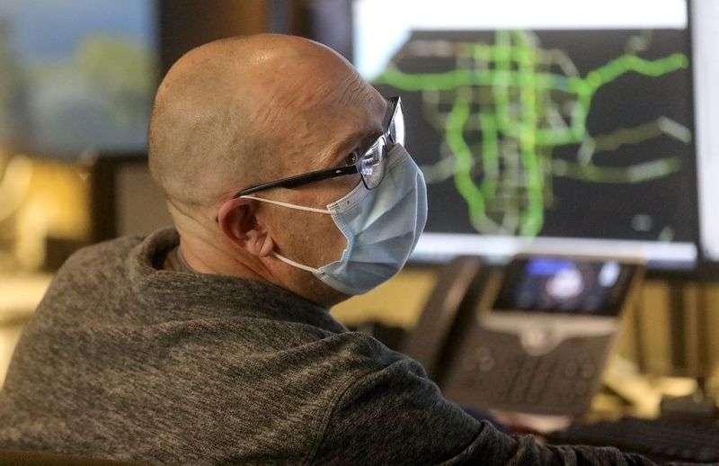 Scott Fugate, Utah Department of Transportation control
room supervisor, coordinates with signal monitors, weather monitors
and the Utah Highway Patrol while monitoring traffic flow, traffic
cameras and radios at the UDOT Operations Center in Salt Lake City
on Monday, Jan. 24.