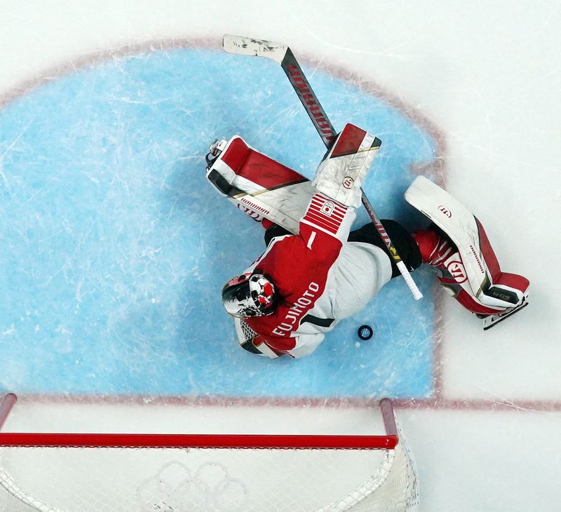 2022 Beijing Olympics - Ice Hockey - Women's Prelim. Round - Group B - China v Japan - Wukesong Sports Centre, Beijing, China - February 6, 2022. Goalkeeper Fujimoto Nana of Japan in action as the puck flies back out after a goal during penalty shootout.