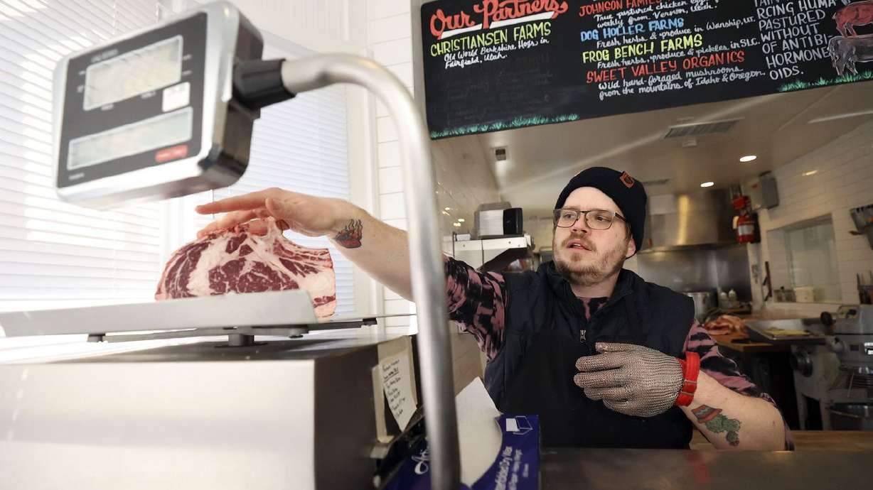 Butcher Jackson Hohler weighs a cut of ribeye for a customer at Beltex Meats in Salt Lake City on Friday.
