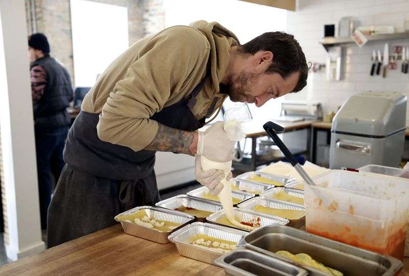 Chef Stephen Lott makes lasagna using pasta and ricotta
cheese made in-house at Beltex Meats in Salt Lake City on Friday.