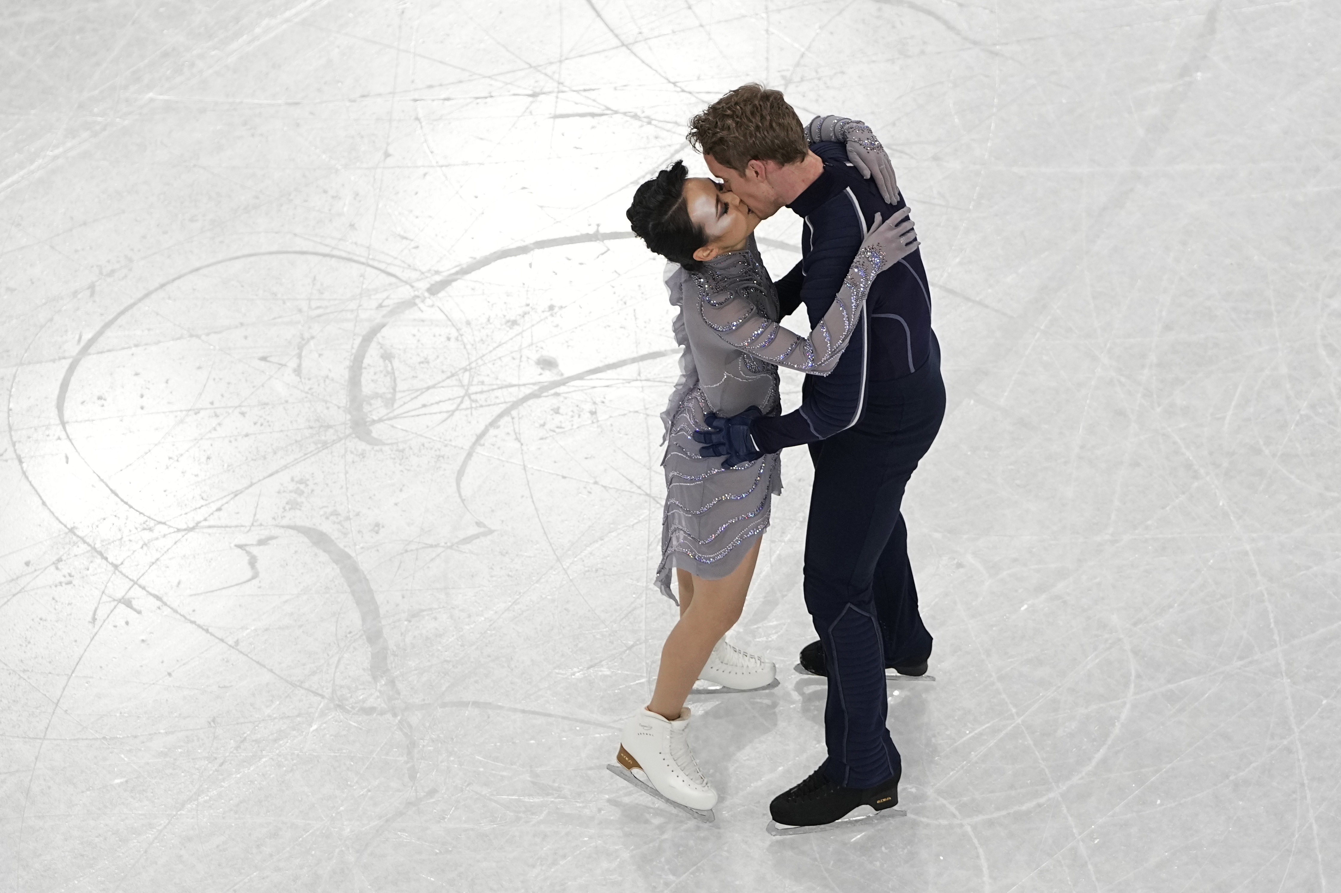 Madison Chock and Evan Bates, of the United States, kiss after completing their routine in the team ice dance program during the figure skating competition at the 2022 Winter Olympics, Monday, Feb. 7, 2022, in Beijing. 