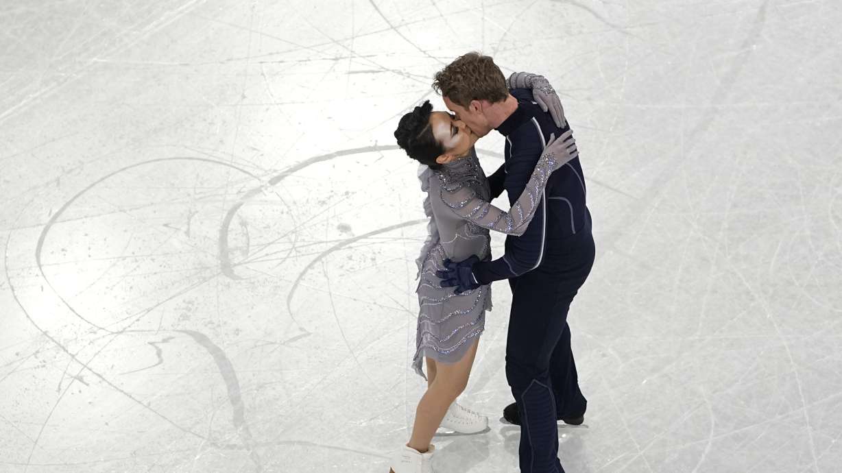 Madison Chock and Evan Bates, of the United States, kiss after completing their routine in the team ice dance program during the figure skating competition at the 2022 Winter Olympics, Monday, Feb. 7, 2022, in Beijing.