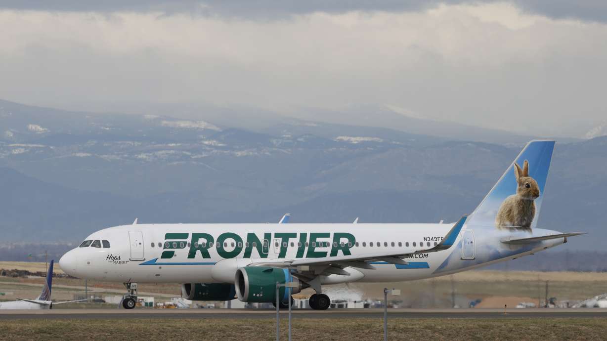 A Frontier Airlines jetliner taxis to a runway to take off April 23, 2020, in Denver. Frontier Airlines' parent company is buying Spirit Airlines in a $2.9 billion cash-and-stock deal.