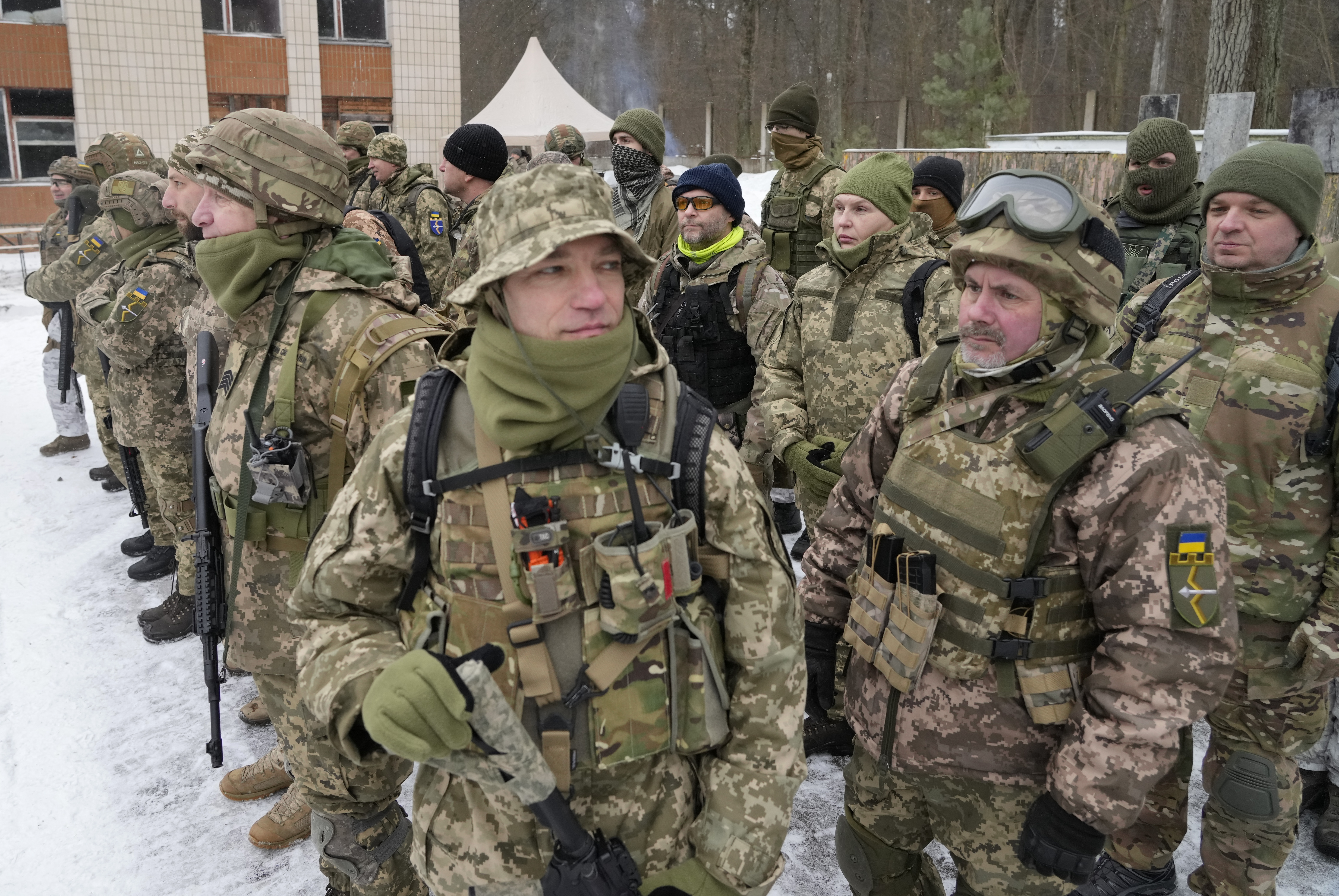 Members of Ukraine's Territorial Defense Forces, volunteer military units of the Armed Forces, train close to Kyiv, Ukraine, Saturday. Hundreds of civilians have been joining Ukraine's army reserves in recent weeks amid fears about Russian invasion.