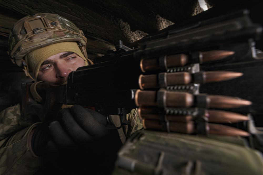 A Ukrainian serviceman mans a heavy machine gun at a frontline position in the Luhansk region, eastern Ukraine, Monday.