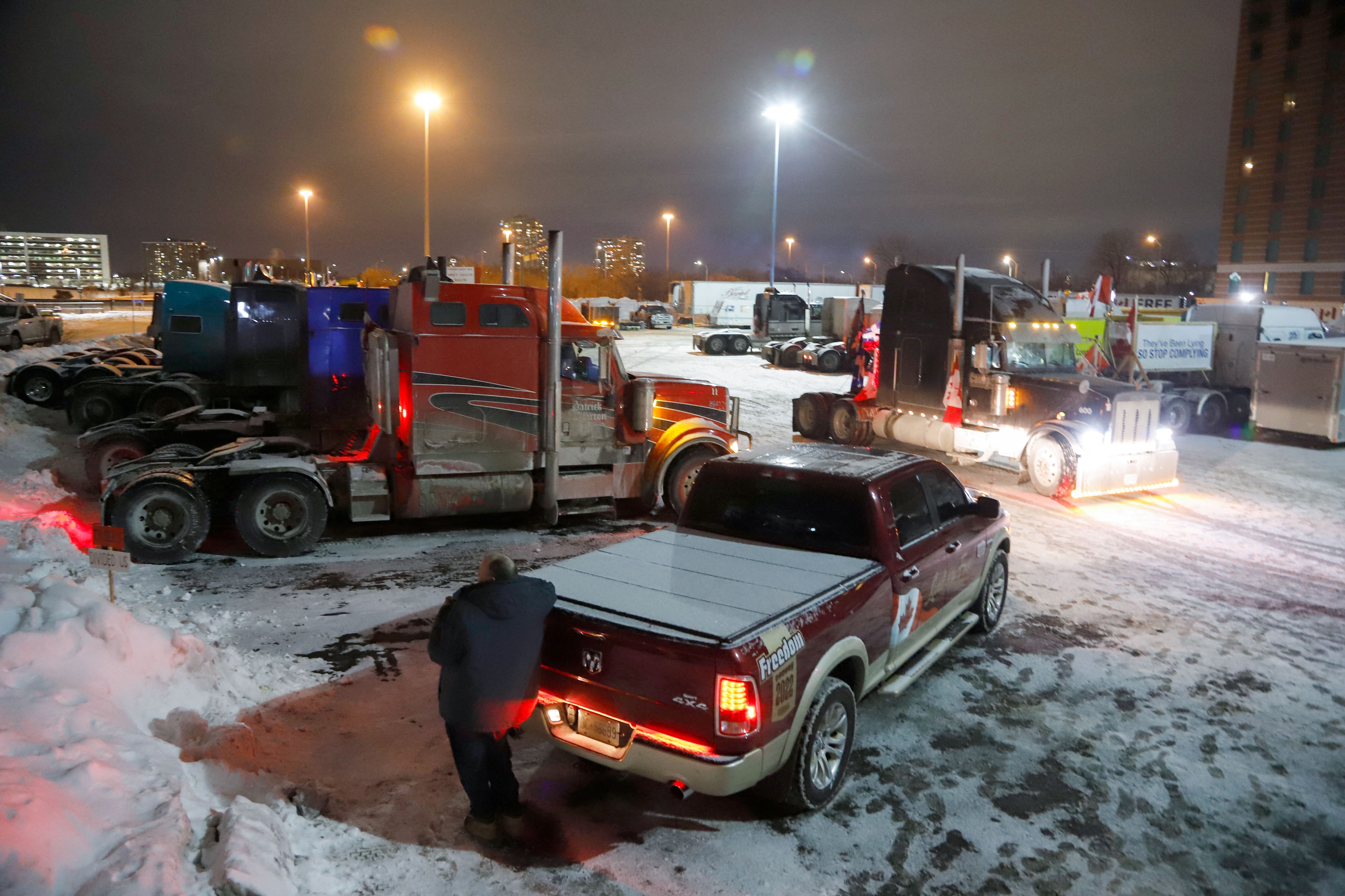 Trucks sit in a staging area east of downtown after police raided the truckers' stockpile of fuel in an attempt to turn up the heat against the protesting truckers while they and their supporters continue to protest against COVID-19 vaccine mandates, in Ottawa, Ontario, Canada, Sunday.