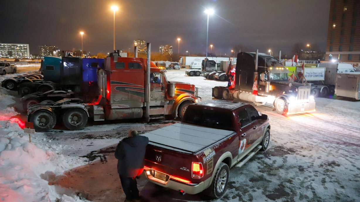 Trucks sit in a staging area east of downtown after police raided the truckers' stockpile of fuel in an attempt to turn up the heat against the protesting truckers while they and their supporters continue to protest against COVID-19 vaccine mandates, in Ottawa, Ontario, Canada, Sunday.