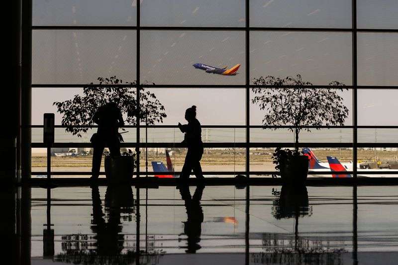 A Southwest Airlines plane takes off as workers work at
the Salt Lake City International Airport on Sept. 15, 2021.