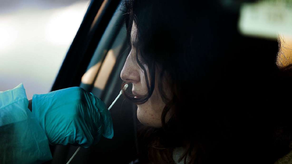 Emilia Lewis, 17, gets a COVID-19 test at the Cannon Health Building in Salt Lake City on Dec. 15, 2021. The pause on rapid COVID-19 tests conducted by the Utah Department of Health could turn out to be permanent.