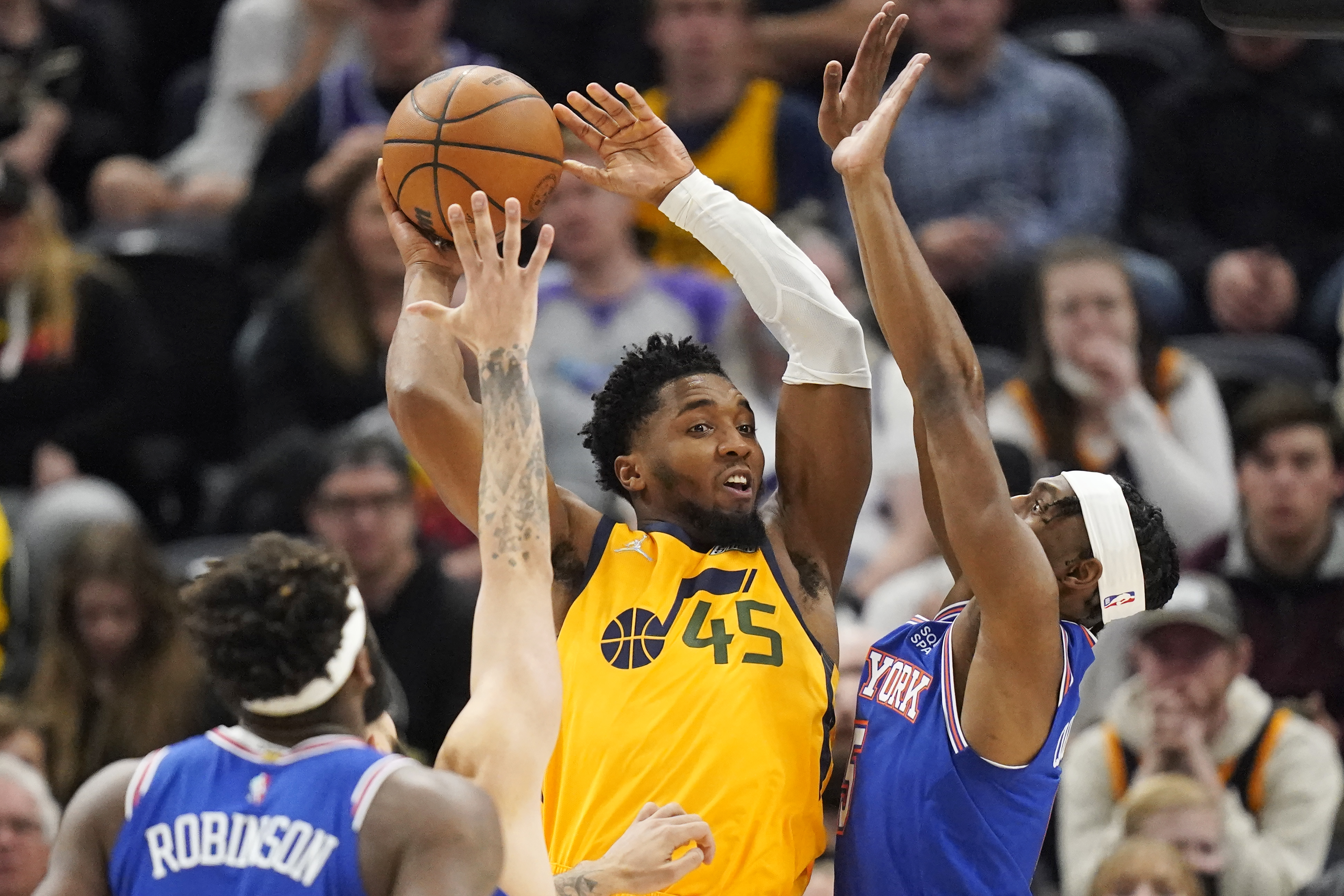 New York Knicks guard Immanuel Quickley, right, defends against Utah Jazz guard Donovan Mitchell (45) in the first half of an NBA basketball game, Monday, Feb. 7, 2022, in Salt Lake City. 
