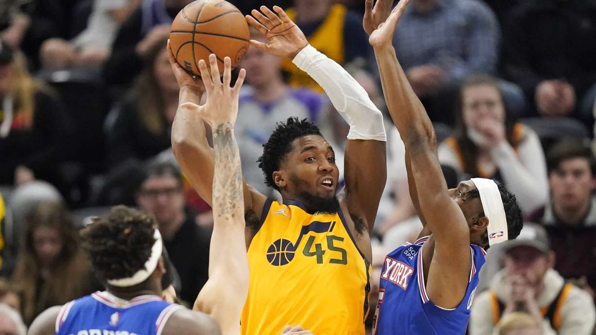 New York Knicks guard Immanuel Quickley, right, defends against Utah Jazz guard Donovan Mitchell (45) in the first half of an NBA basketball game, Monday, Feb. 7, 2022, in Salt Lake City.